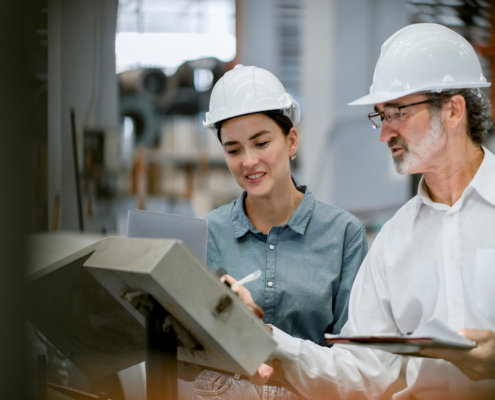 Portrait of engineer team standing and working in industrial factory