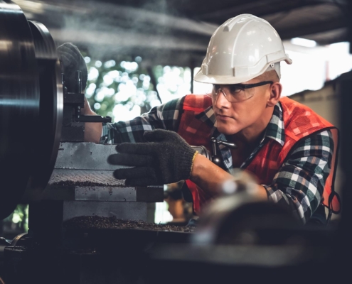 Worker inspecting machinery